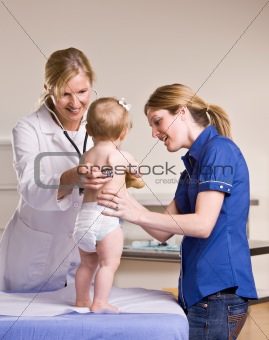 Doctor giving baby girl checkup in doctorÕs office