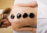 Woman receiving hot stone therapy massage