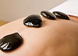 Woman receiving hot stone therapy massage