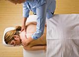 Massage therapist giving woman massage