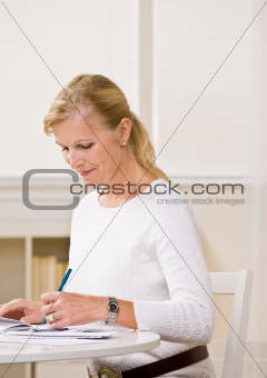 Woman writing checks