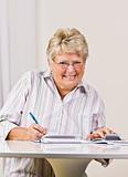 Senior woman writing checks