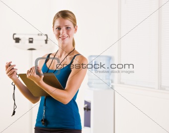 Woman holding stopwatch and clipboard