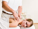 Massage therapist giving woman massage