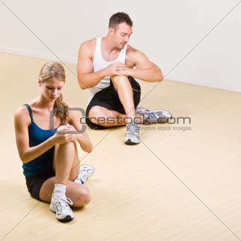 People stretching in health club