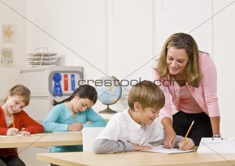 Teacher helping student in classroom