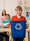 Girl holding recycling bin