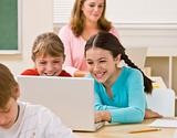 Girls using laptop in classroom
