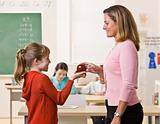 Student giving teacher apple