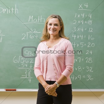 Teacher standing near blackboard