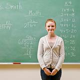 Student standing near blackboard