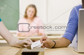 Students passing notes in classroom
