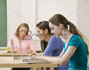 Students using laptops in classroom