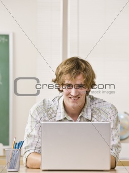 Student typing on laptop