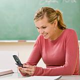 Student text messaging on cell phone in classroom