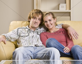 Couple sitting together on sofa