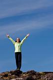 Woman Celebrating Achievement At The Top Of A Mountain