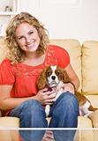 Woman sitting on sofa with dog
