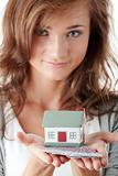 Young woman holding euros bills and house model