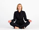 Mature businesswoman meditating with clossed eyes