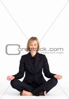 Mature businesswoman doing meditation exercises