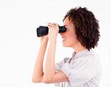 Smiling brunette businesswoman looking through binoculars 