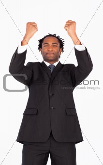Young businessman with raised arms 