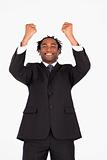 Smiling businessman with raised arms 