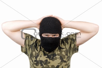 The surrendered terrorist in a black mask over white