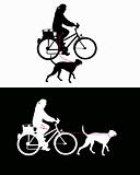 Women on bicycle with dogs on leash