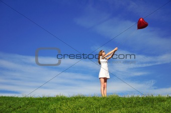 girl with a red baloonl in the form of heart