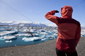 Female Hiker Looking at Iceberg Filled Lagoon, Jokulsarlon, Icel