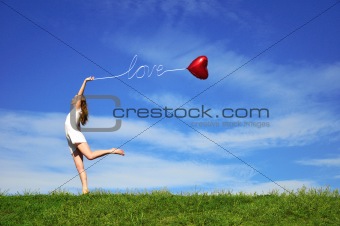 girl with a red ball in the form of heart