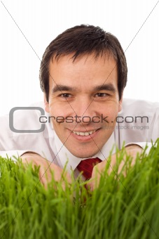 Businessman hiding in grass - isolated