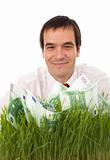Confident businessman with green banknotes in the grass - isolat