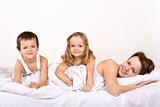 Happy people posing for a family portrait in bed