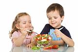 Happy kids eating fruit salad