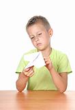 boy makes paper plane