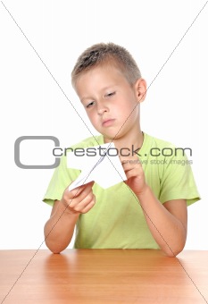 boy makes paper plane