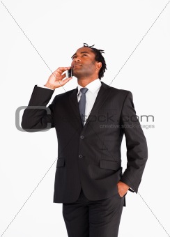 Businessman talking on the phone looking upwards