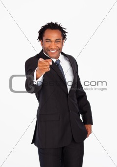 Smiling businessman pointing at the camera 