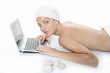 Beautiful woman in spa working with laptop