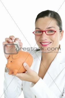 Beautiful businesswoman with piggybank  over white