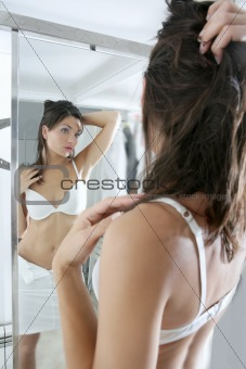 Beautiful sexy young woman posing mirror