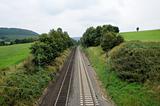 Railroad track throw green landscape