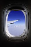 aeroplane window with blue skies