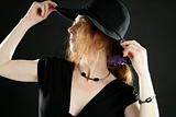 beautiful redhead woman in black, hat and jewels