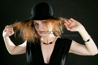 beautiful redhead woman in black, hat and jewels
