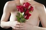 Romantic nude woman holding red roses