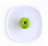Green apple in the plate